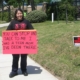 Woman holds a sign that reads "You can stop and talk to me. I was a teen mom. I've been there."