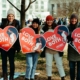 Young women holding "Love Them Both" signs
