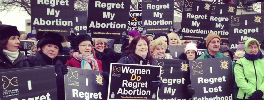 Crowd with "I Regret My Abortion" signs
