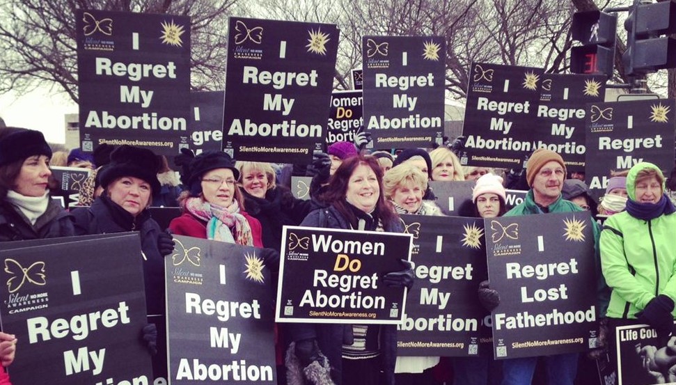 Crowd with "I Regret My Abortion" signs