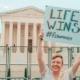 Pro-life advocate Herb Geraghty holds a "Life Wins" sign outside the Supreme Court building