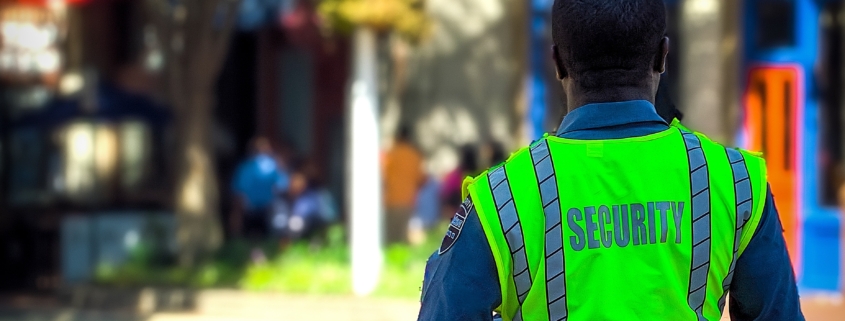 A security guard on a sunny street