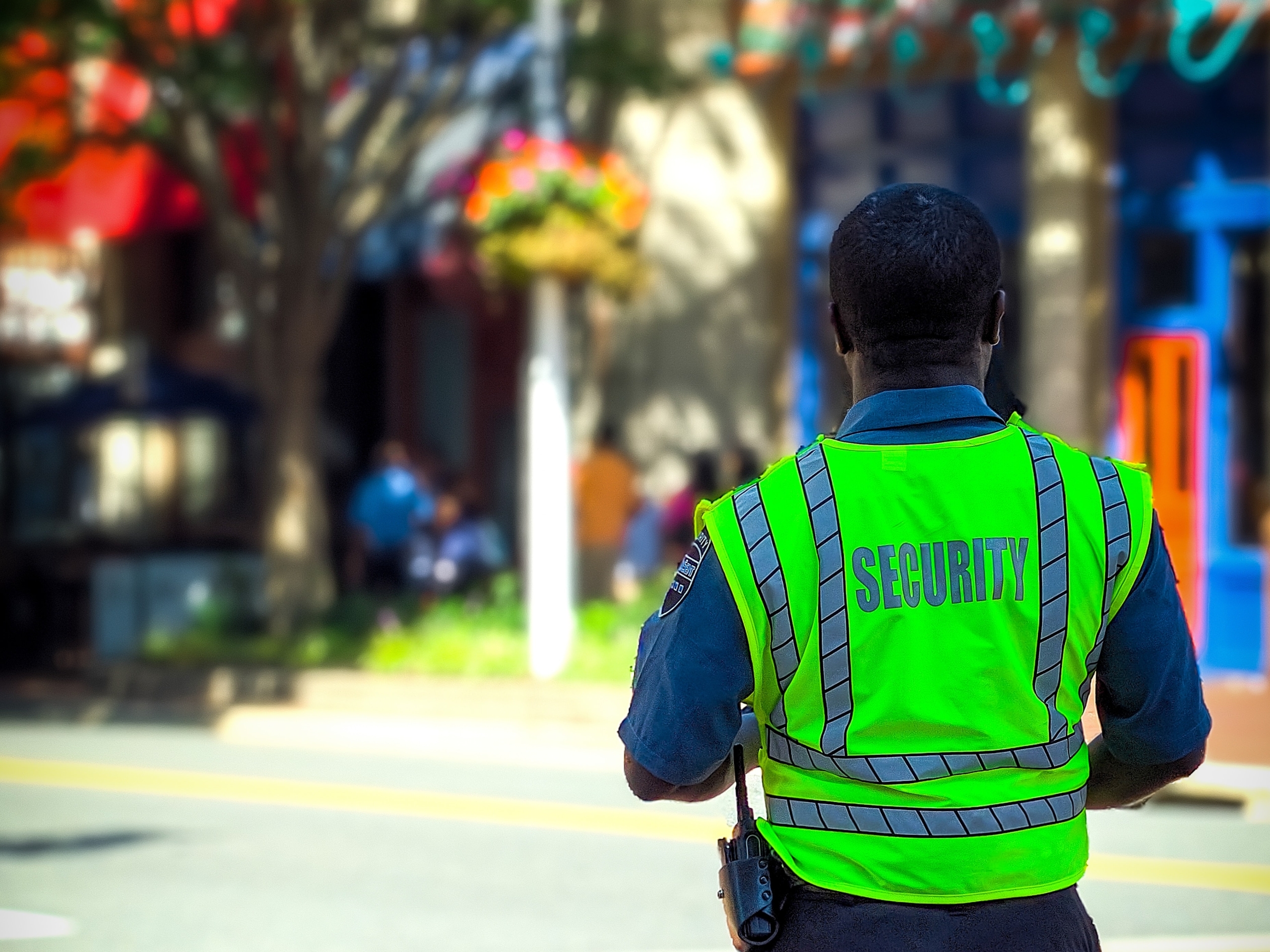 A security officer on a sunny street