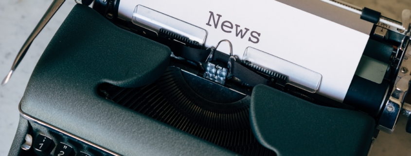 Typewriter printing the word "News"