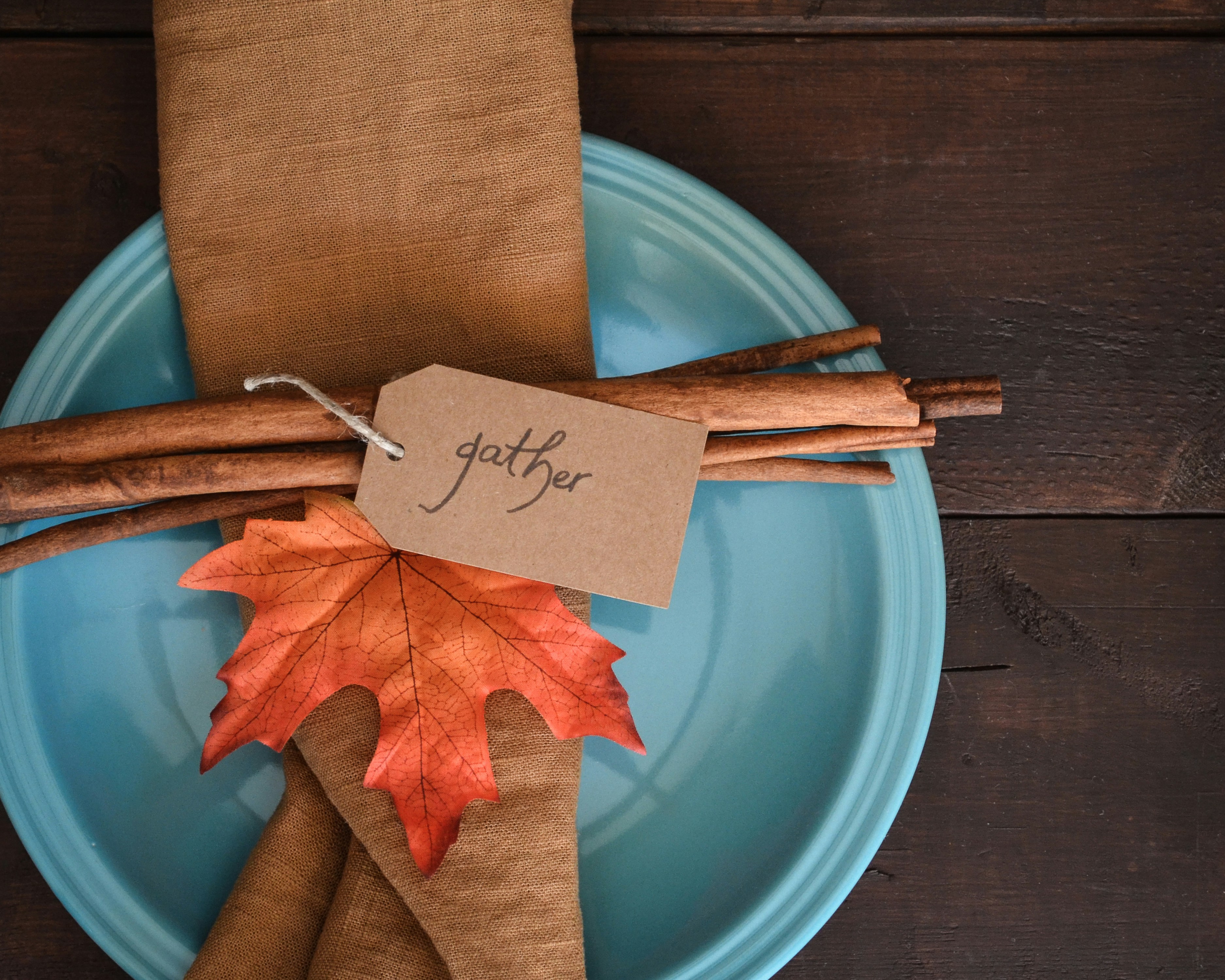 Fall themed place setting with the word "gather"
