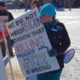 Woman with sign: we do not need religion