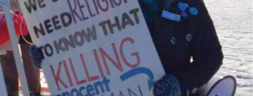 Woman with sign: we do not need religion